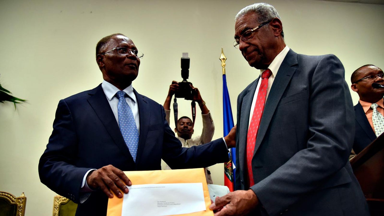 El presidente interino de Haití, Jocelerme Privert (a la izquierda), recibe el informe sobre los resultados de la primera vuelta de las presidenciales de manos del responsable de la Comisión de Verificación, François Benoît