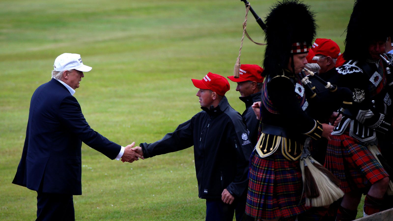 Republican presidential candidate Donald Trump shakes hands with a supporter after getting off his helicopter at Turnberry Golf course in  Turnberry,