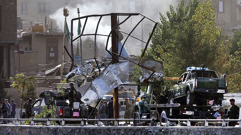 Varios agentes de seguridad afganos inspeccionan el lugar del atentado perpetrado cerca del ministerio de Defensa en Kabul.