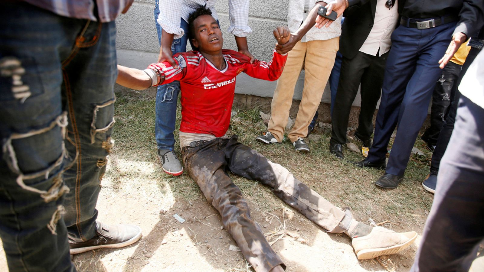 People assist an injured protestor during Irrechaa, the thanks giving festival of the Oromo people in Bishoftu town of Oromia region, Ethiopia