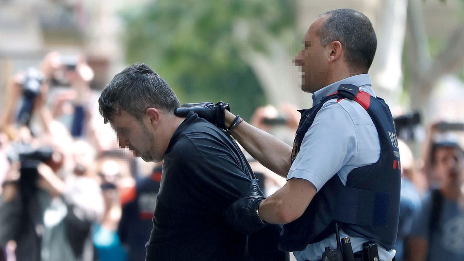 Imagen del pasado martes 5 de junio de los Mossos d'esquadra custodiando al detenido a su llegada a su domicilio para participar en el registro de dicha vivienda.