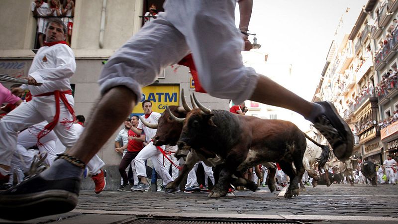 Gente corriendo los encierros de San Fermín