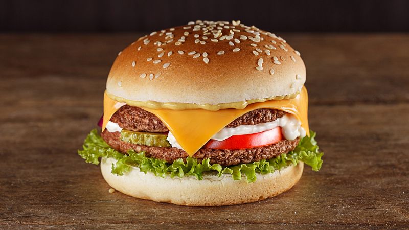 Fresh tasty burger on wooden board