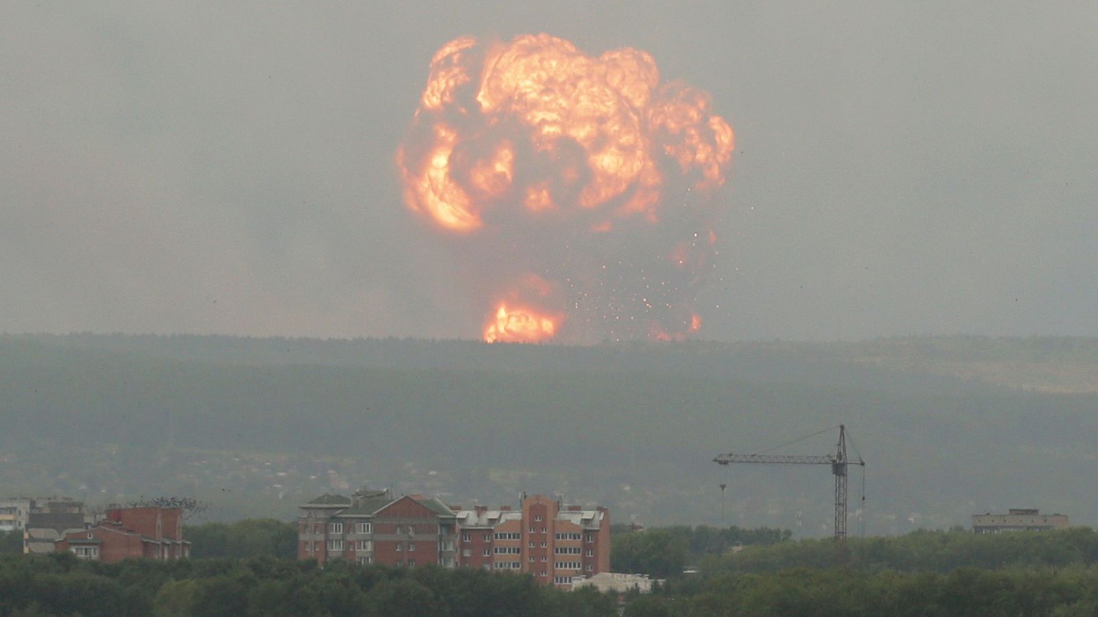 A view shows flame and smoke rising from the site of blasts at an ammunition depot in Krasnoyarsk region