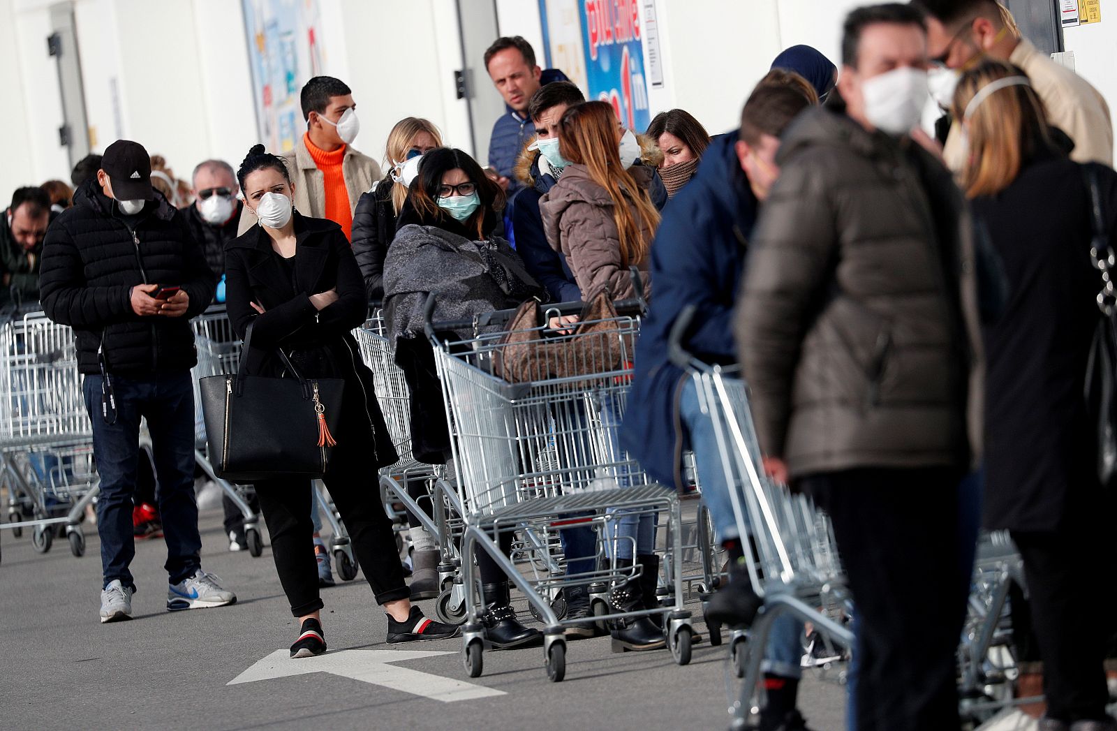 Varias personas hacen cola en un supermercado en el municipio italiano de Casalpusterlengo