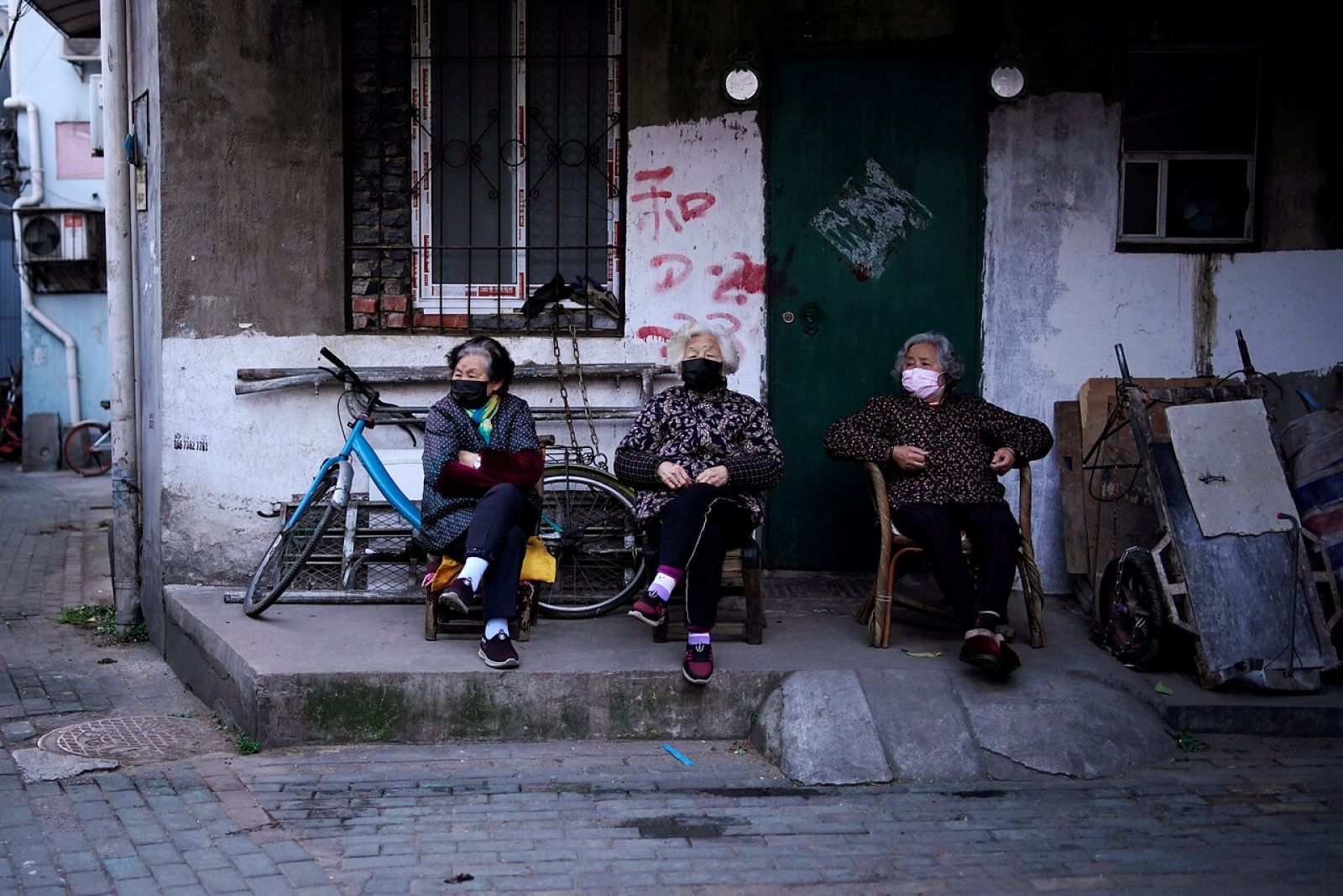 Residentes con máscaras en una zona residencial bloqueada en Wuhan
