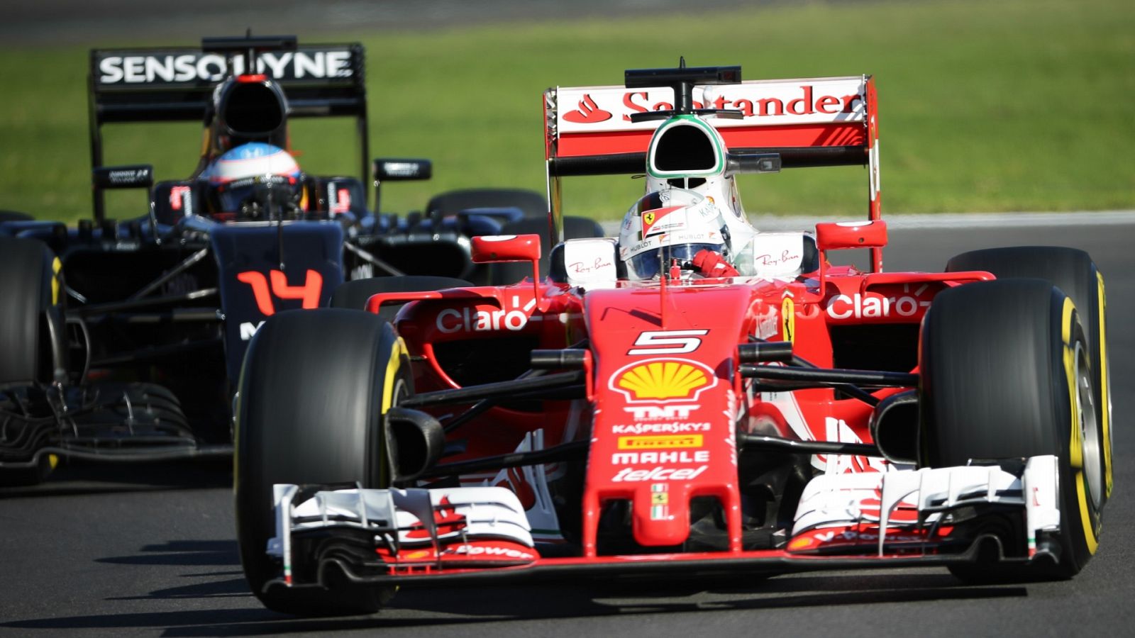 El alemán Sebastian Vettel, de Ferrari, (d) y el español Fernando Alonso, de McLaren, (i),