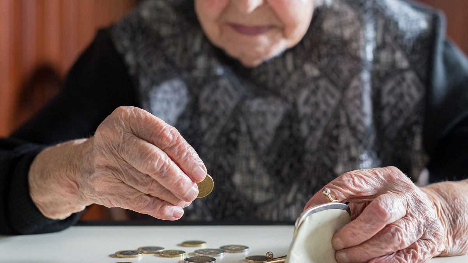 Una mujer mayor cuenta monedas