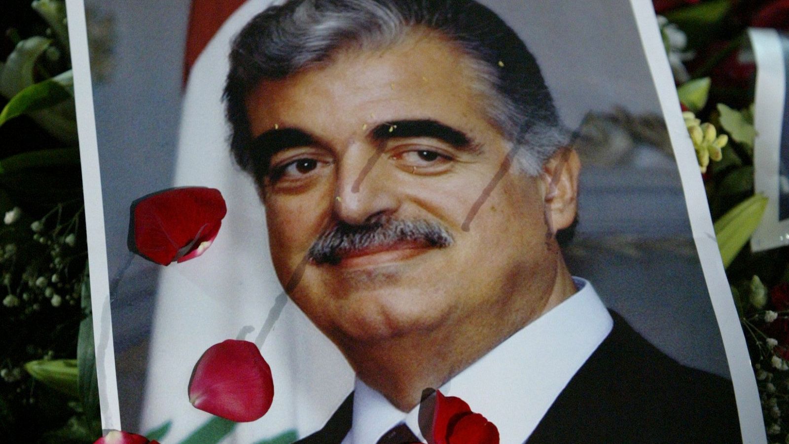 En esta foto de archivo tomada el 16 de febrero de 2005, la tumba del ex primer ministro libanés asesinado Rafiq Hariri (retrato) está cubierta de flores después de su funeral en el centro de Beirut.