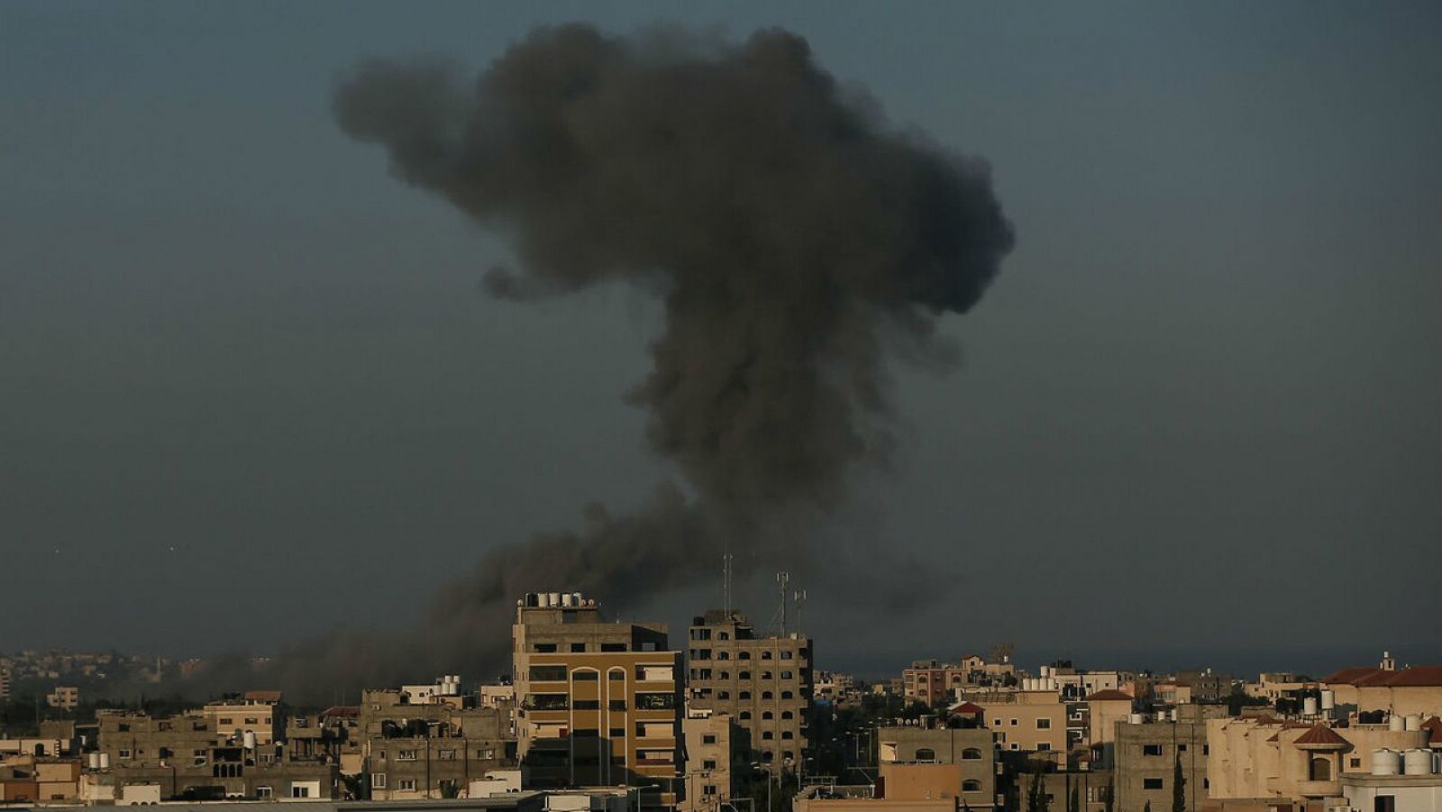 Humo entre edificios después de que aviones de guerra pertenecientes al ejército israelí llevaran a cabo ataques aéreos sobre la ciudad de Gaza. 