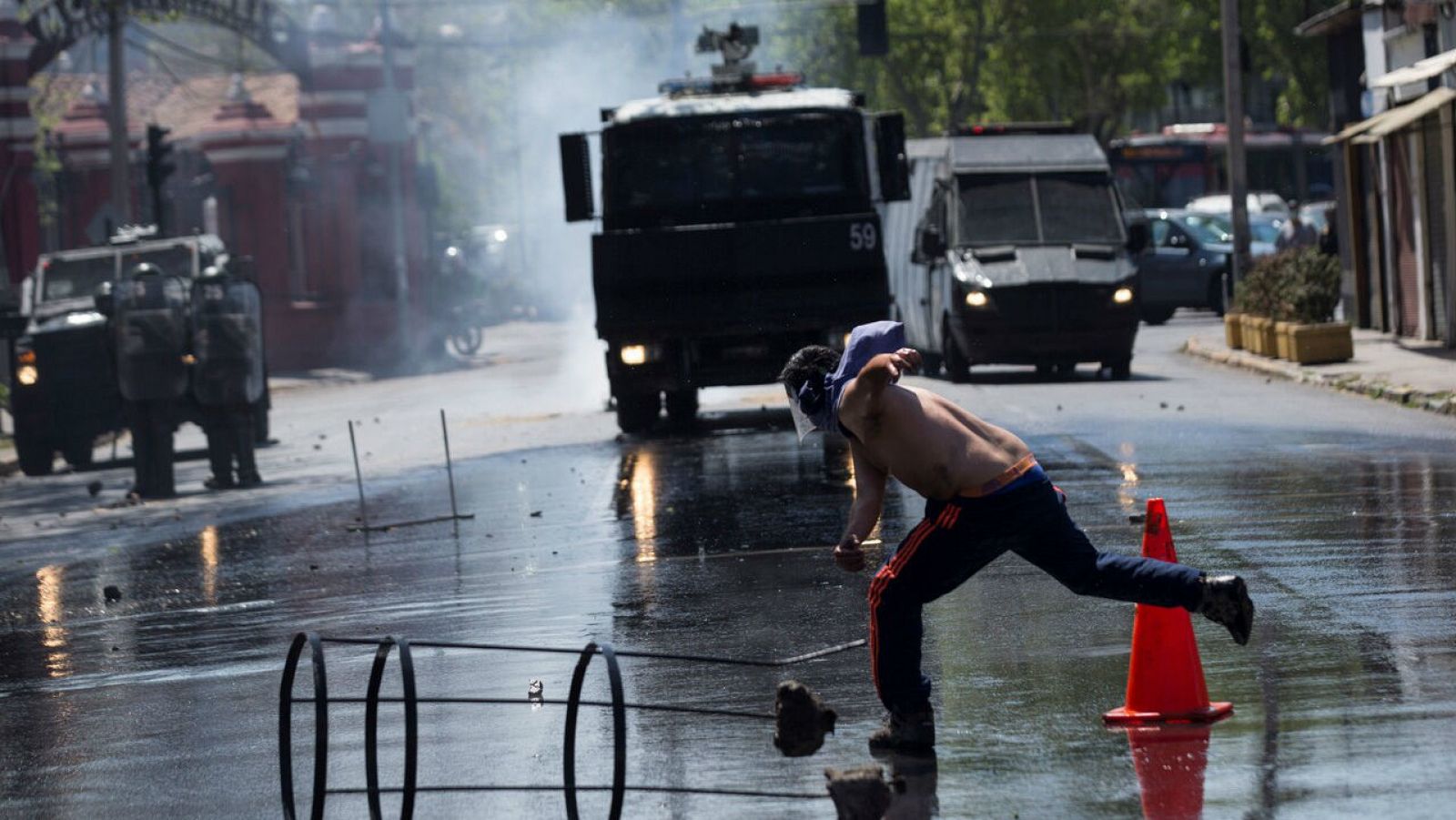 Manifestantes se enfrentan con las Fuerzas Especiales de Carabineros en la entrada de la Clínica Santa María en Santiago (Chile). 