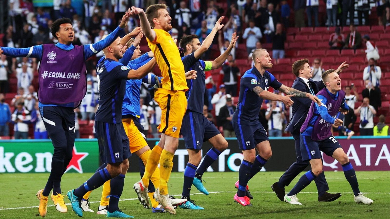 Los jugadores de la selección de Finlandia celebran la victoria sobre Dinamarca con sus aficionados.