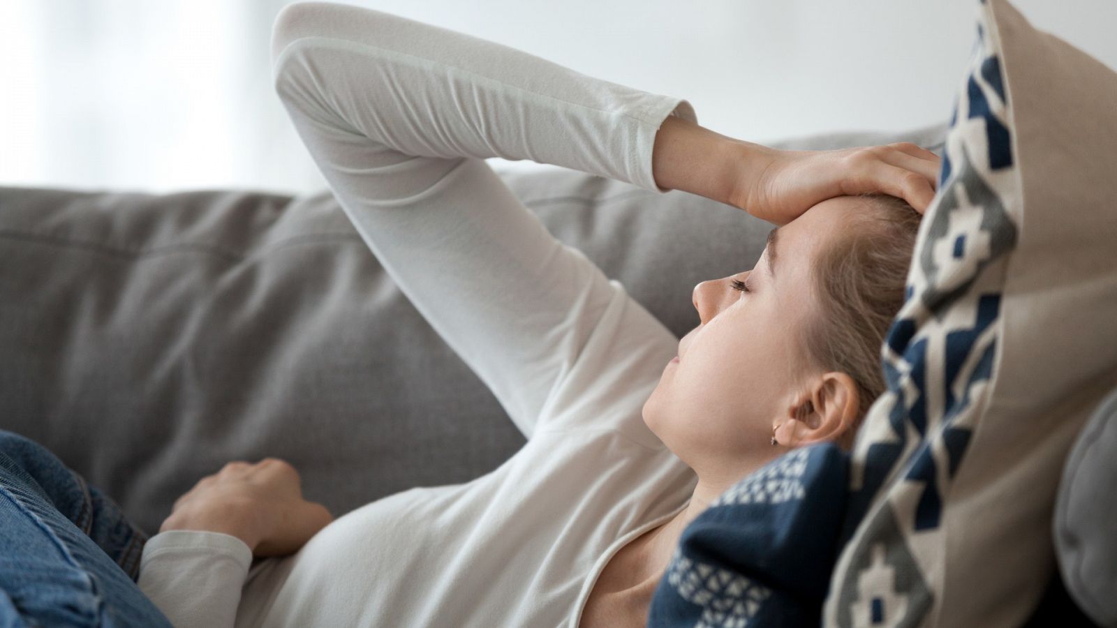 Una mujer se lleva las manos a la cabeza como signo de dolor