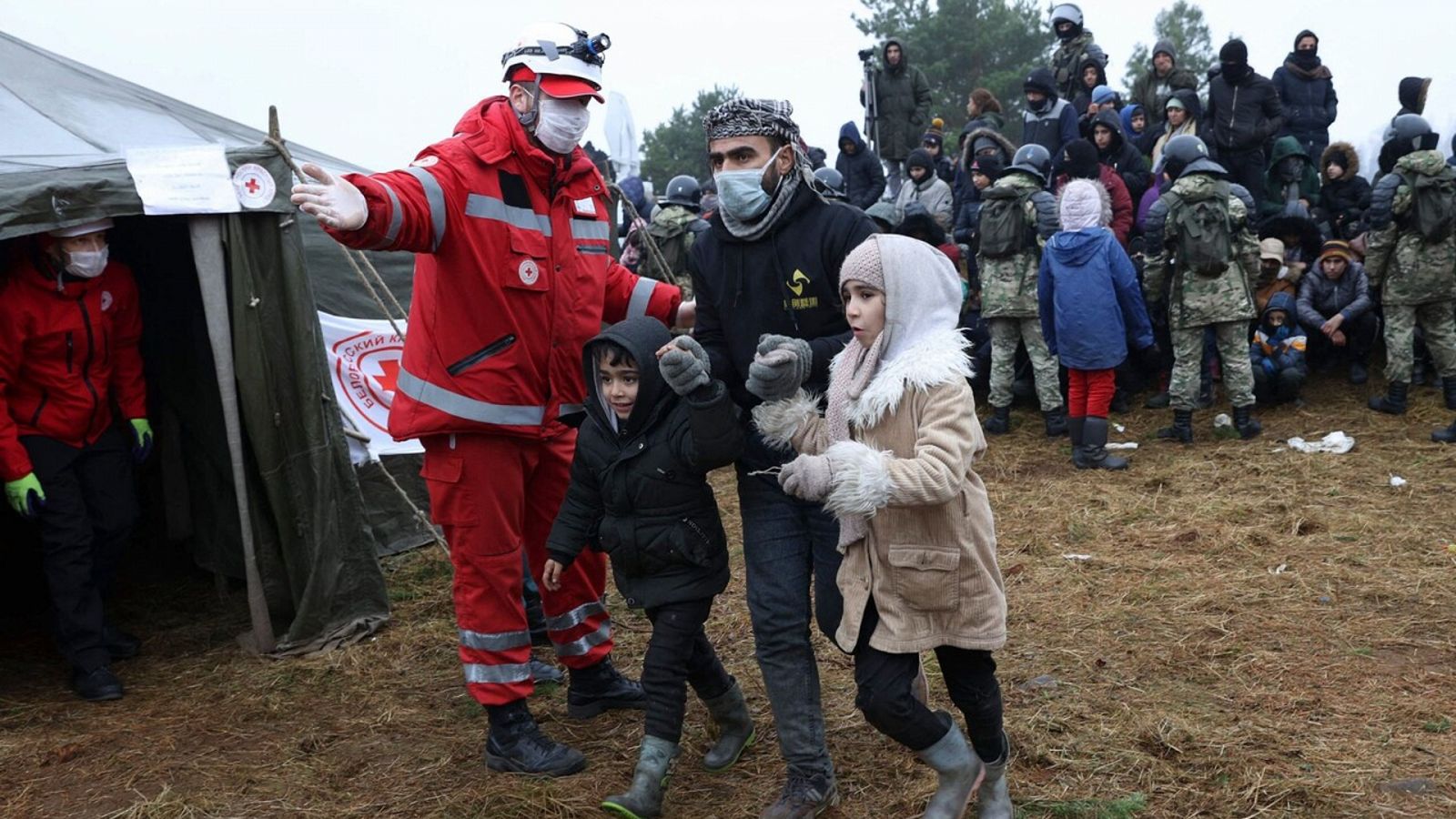 Miembros de la Cruz Roja bielorrusa ayuda a inmigrantes en la frontera con Polonia. Oksana MANCHUK / BELTA / AFP