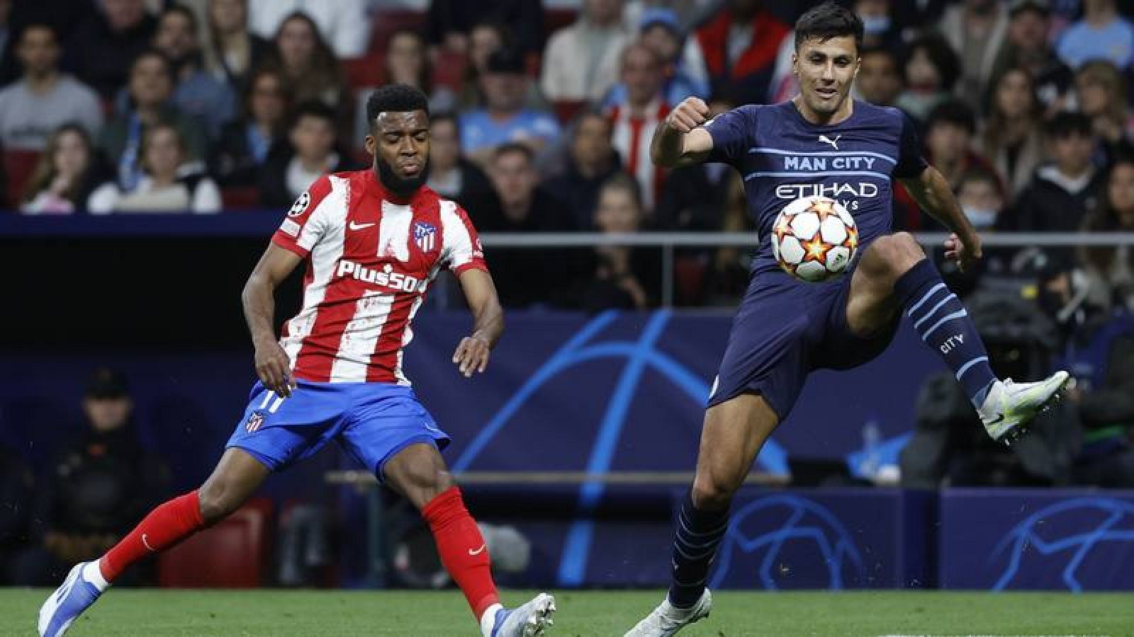Rodrigo intenta despejar el balón ante Thomas Lemar.