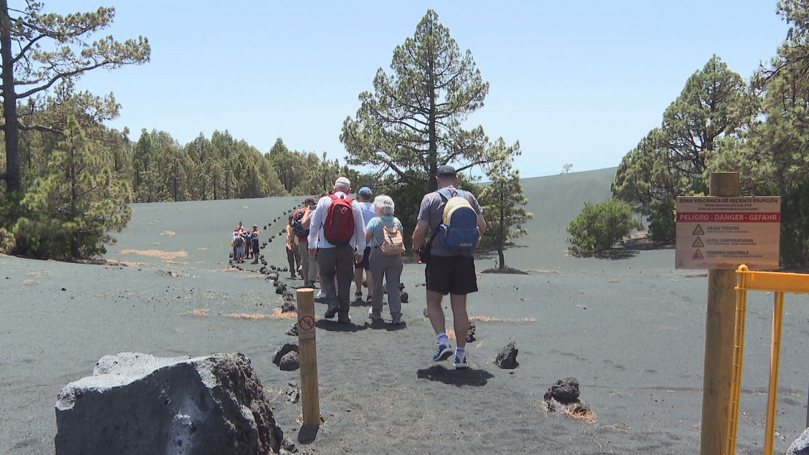 Turistas caminando sobre las cenizas volcánicas del Cumbre Vieja en La Palma