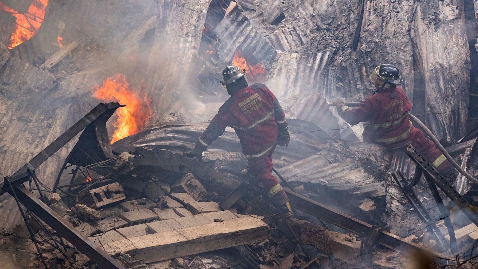 Una pareja de bomberos trabaja en la extinción de un incendio