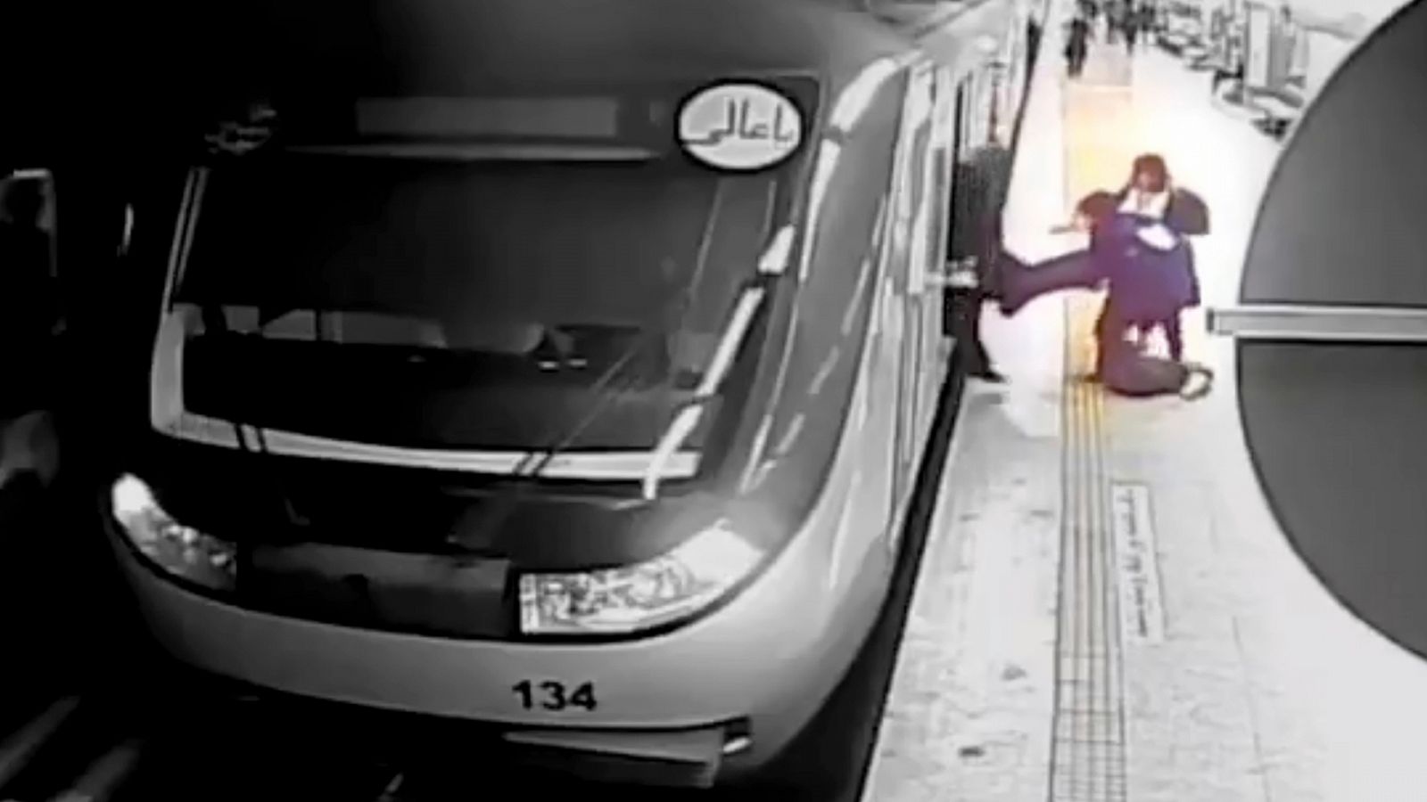 Imagen del vídeo de vigilancia del metro de Irán donde se ve a dos jóvenes sacando a Armita Geravand del vagón.