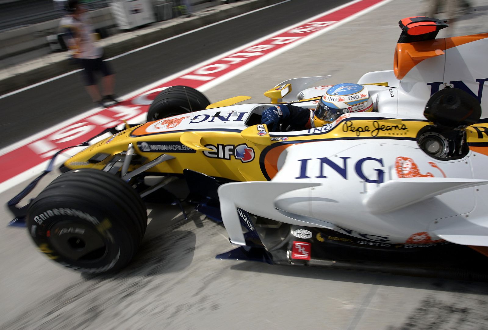 Renault's Formula One driver Fernando Alonso of Spain leaves the pit