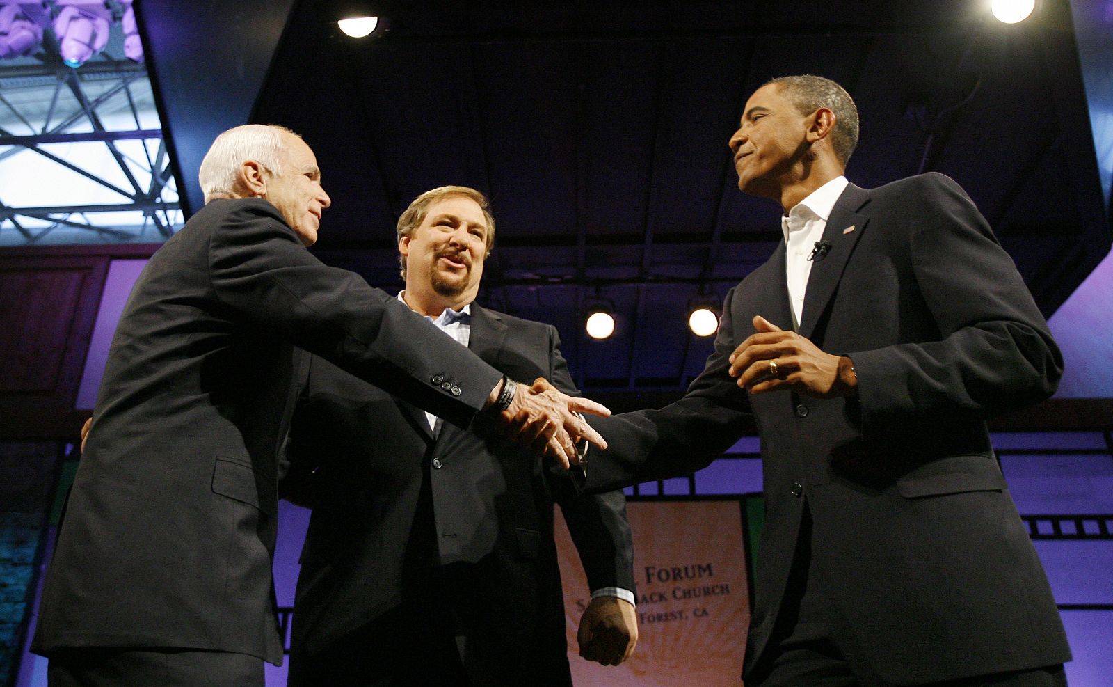 John McCain shakes hands with Barack Obama, as Rick Warren watches, at the Civil Forum on the Presidency at Saddleback Church in Lake Forest