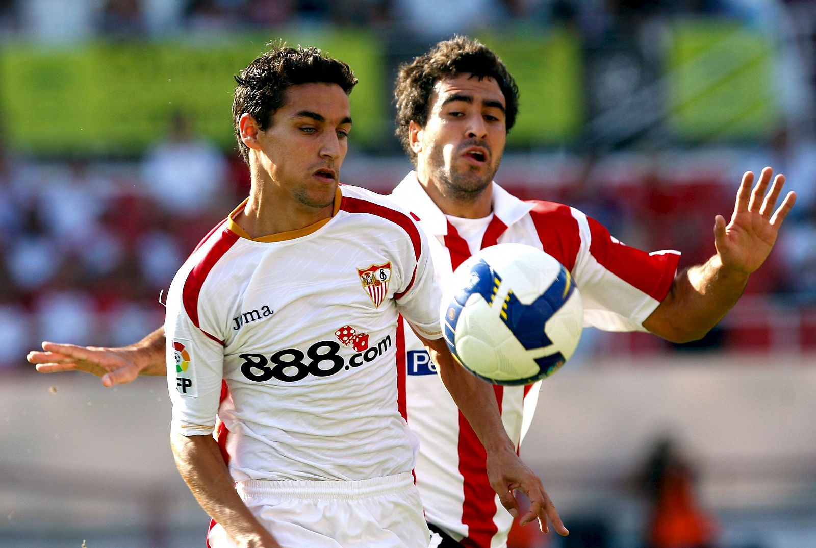 El centrocampista del Sevilla, Jesús Navas, y el defensa del Athletic, Mikel Balenziaga, pugnan por el balón.