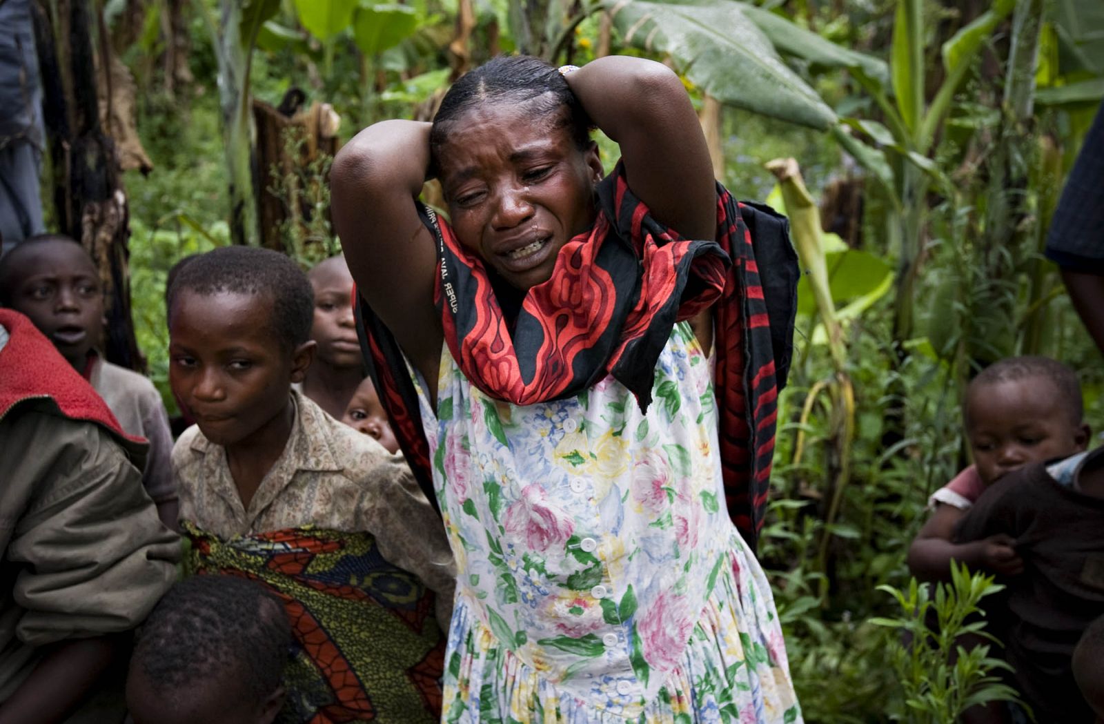 Woman cries at the grave of eight-month old Alexandrine Kabitsebangumi in eastern Congo