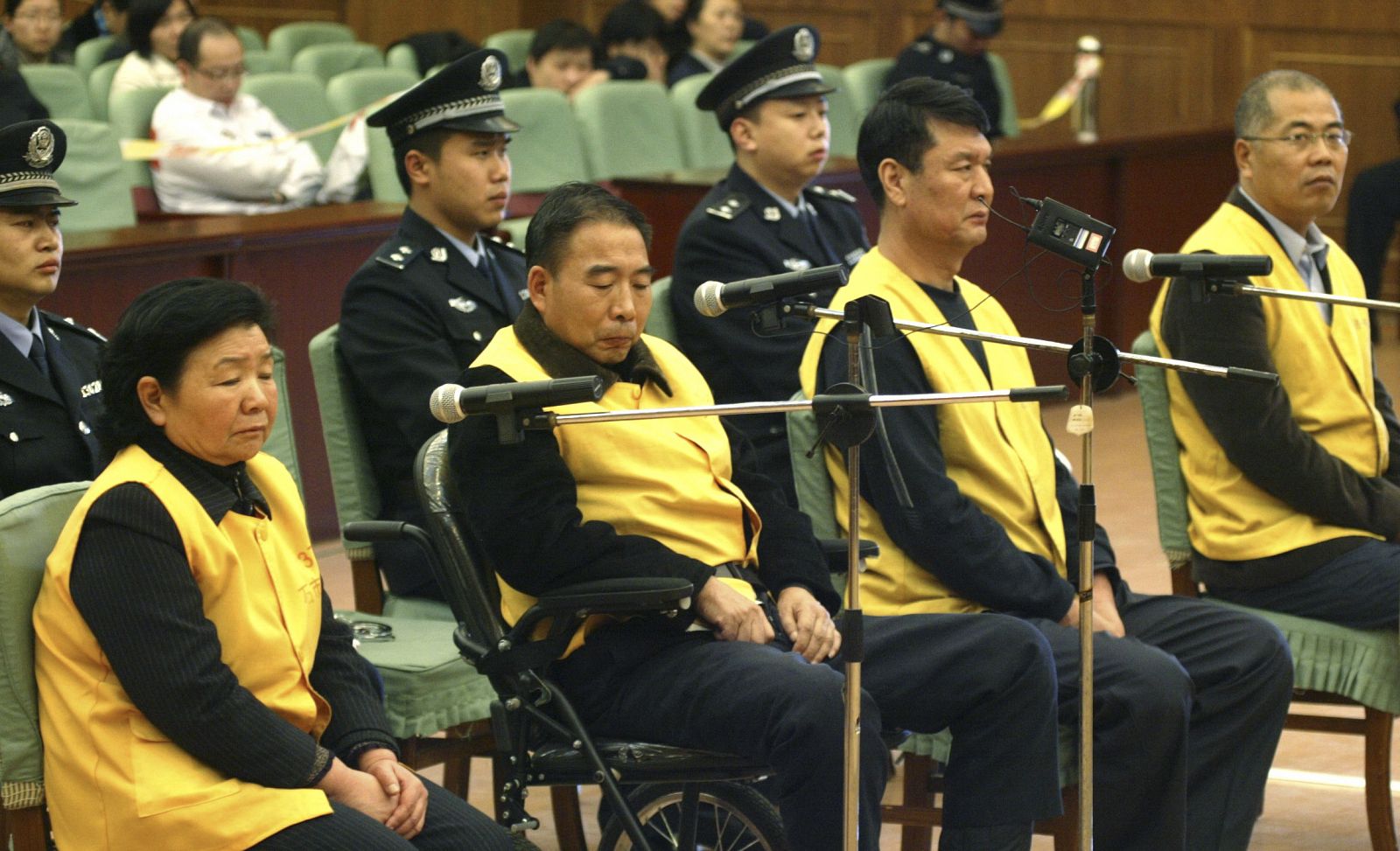 Four former executives of Sanlu Group stand on trial at Shijiazhuang Intermediate People's Court