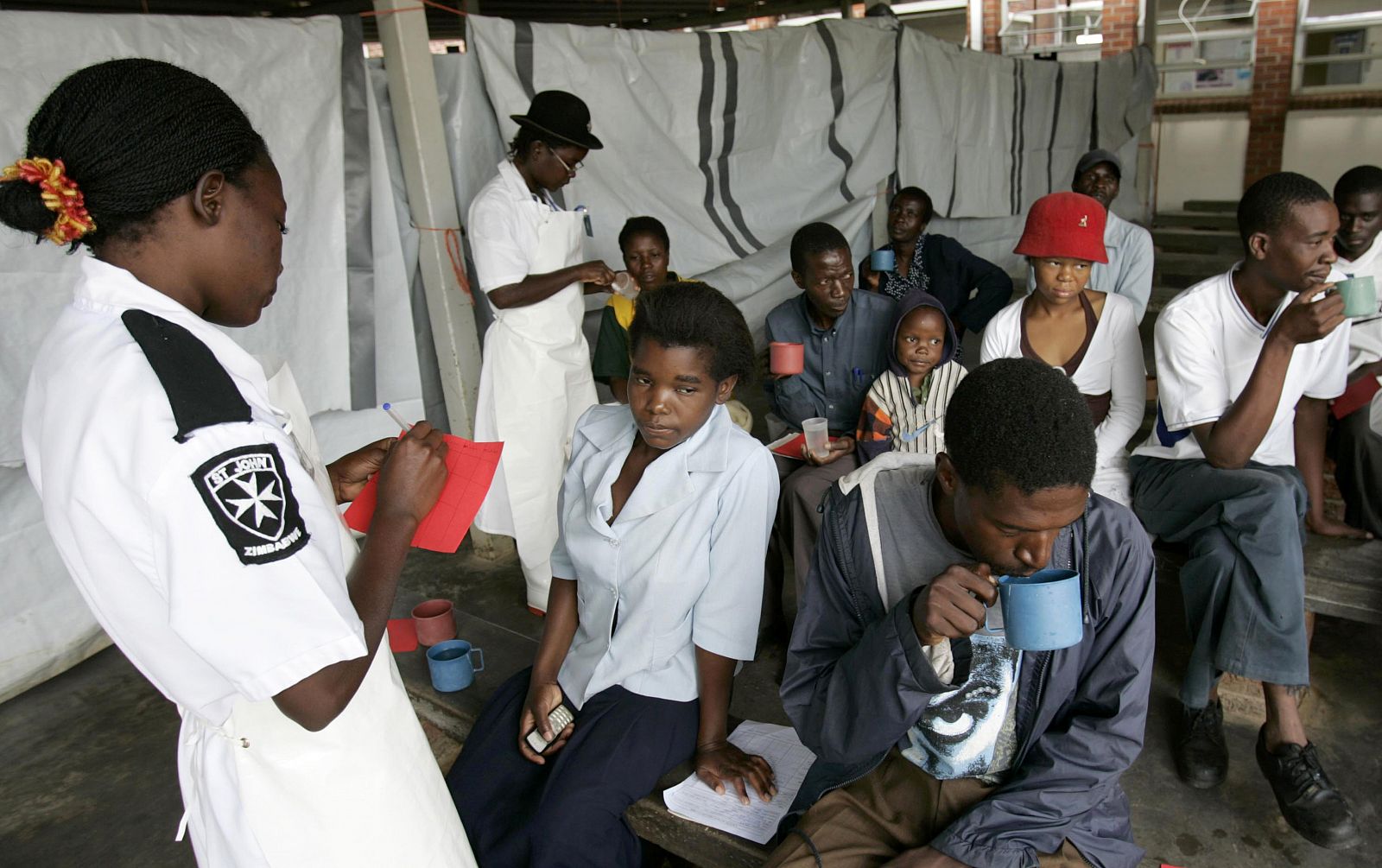 Cholera patients drink treated water inside an admission ward at Budiriro Polyclinic in Harare