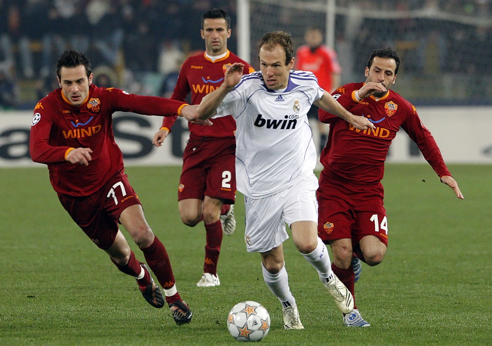 Real Madrid Robben challenges Giuly, Cassetti and Panucci during their Champions League first knockout round, first leg soccer match in Rome