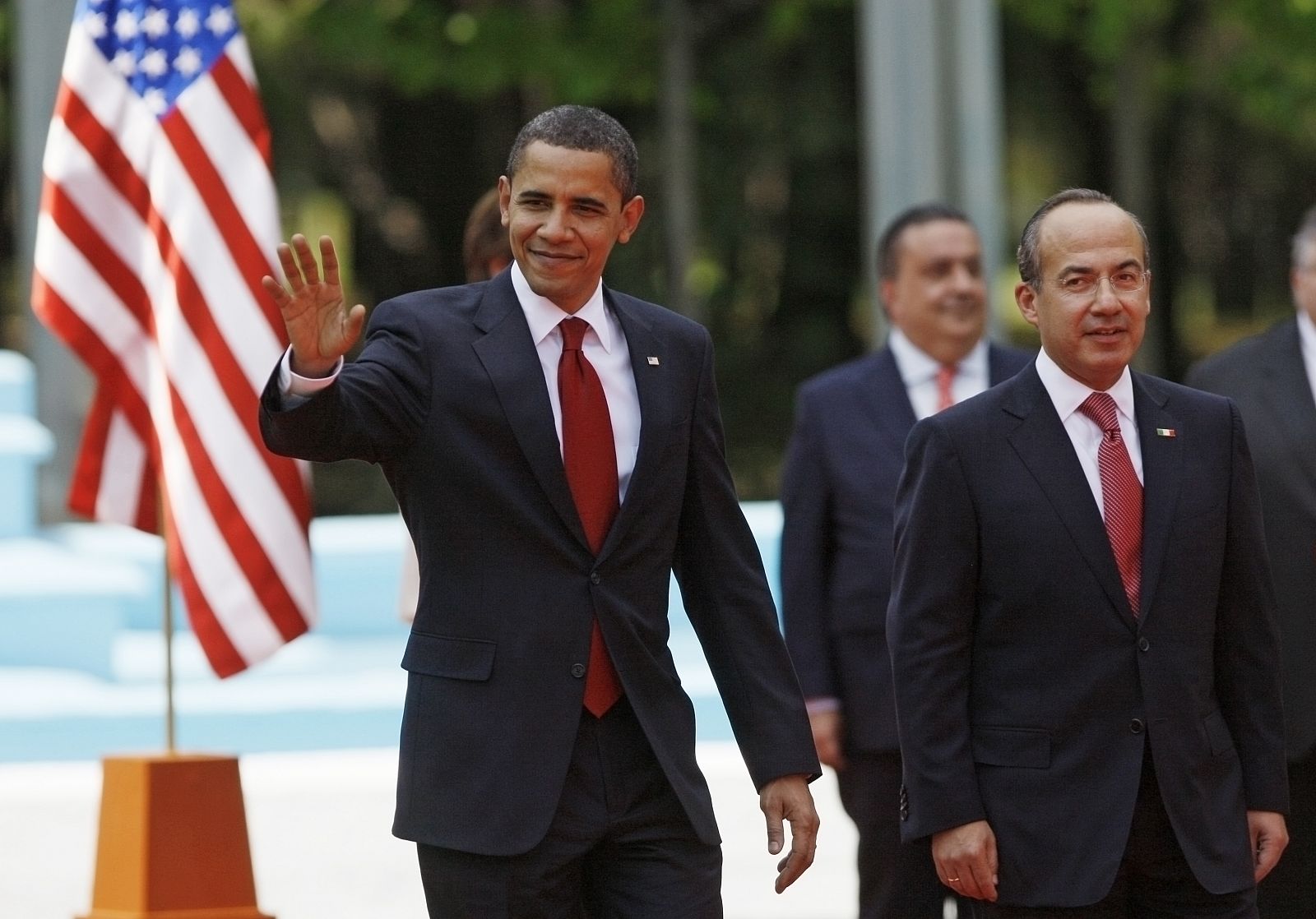 U.S. President Obama waves as he walks with Mexico's President Calderon in Mexico City
