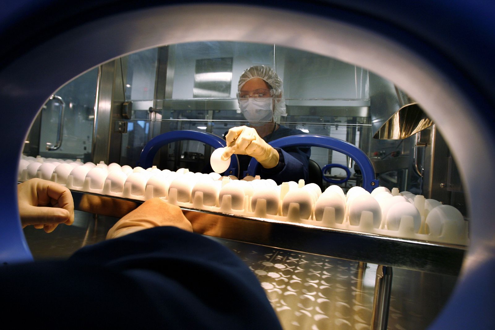 Un científico manipula un huevo en una planta de Sanofi Pasteur para fabricar la vacuna de la gripe