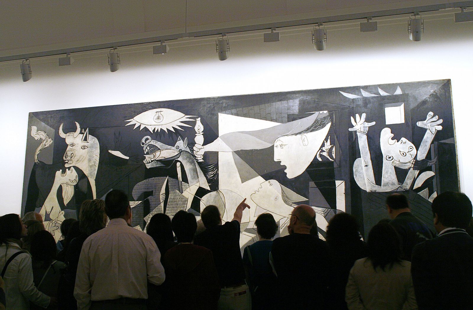 Visitors look at Spanish artist Picasso's "Guernica" in Madrid