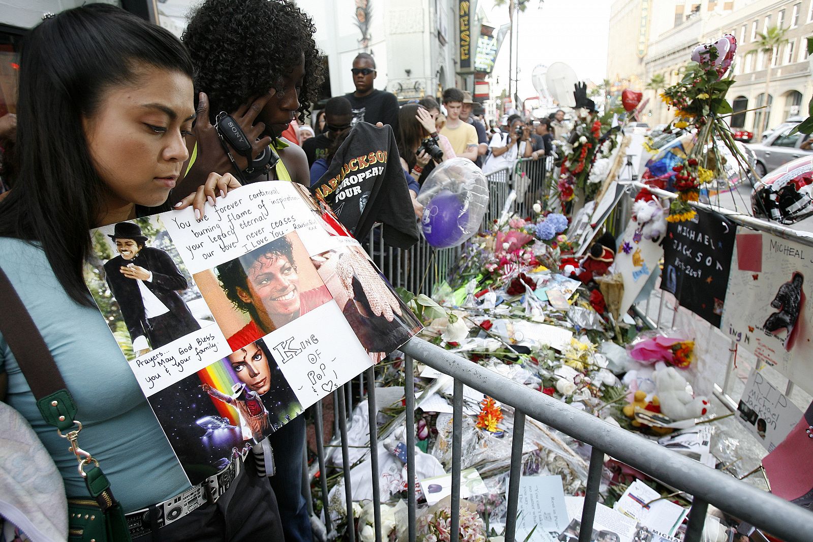 Satya Vanii holds a makeshift memorial as she walks by the star of deceased pop star Michael Jackson on the Walk of Fame in Hollywood