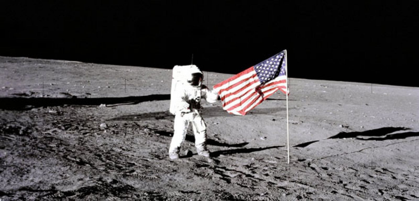 Charles Conrad, tripulante del Apolo 12 en la segunda misión extravehicular en la Luna, junto a la bandera de EEUU.