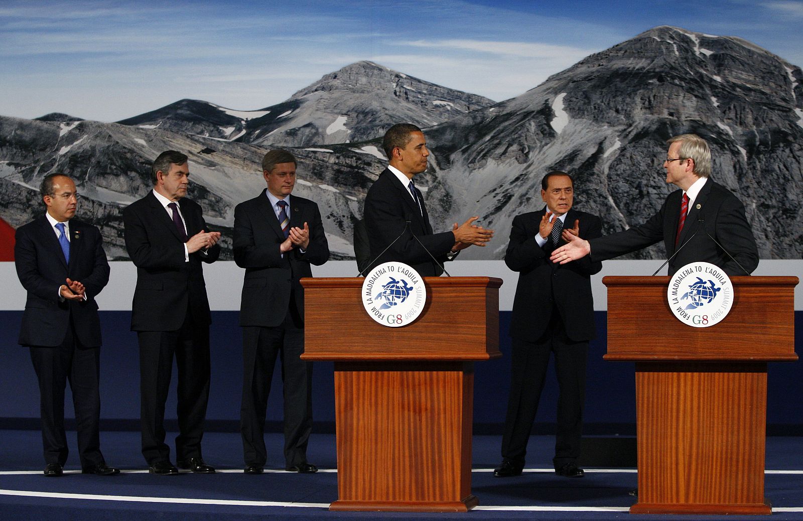 Australia's PM Rudd offers his hand to US President Obama as other leaders clap at the G8 summit in L'Aquila