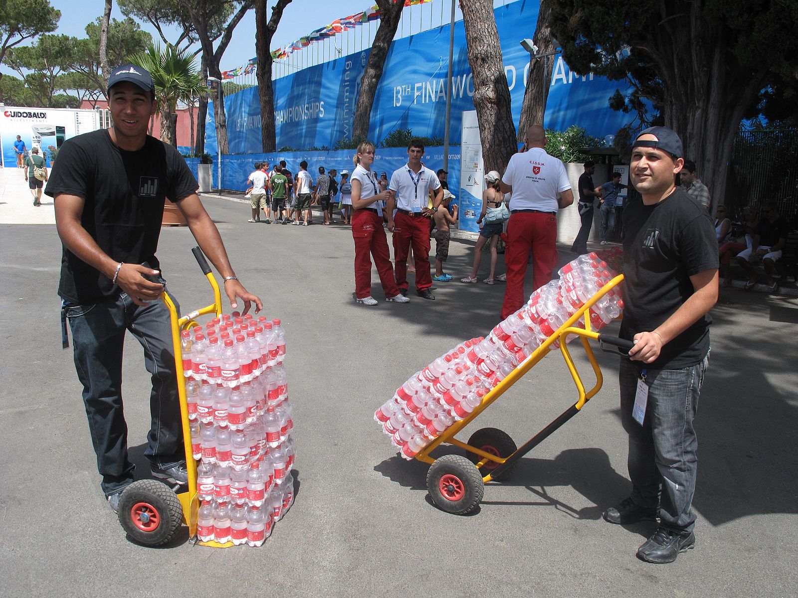 Dos trabajadores distribuyen parte de las 30.000 botellas diarias que se destinan al Foro Itálico.
