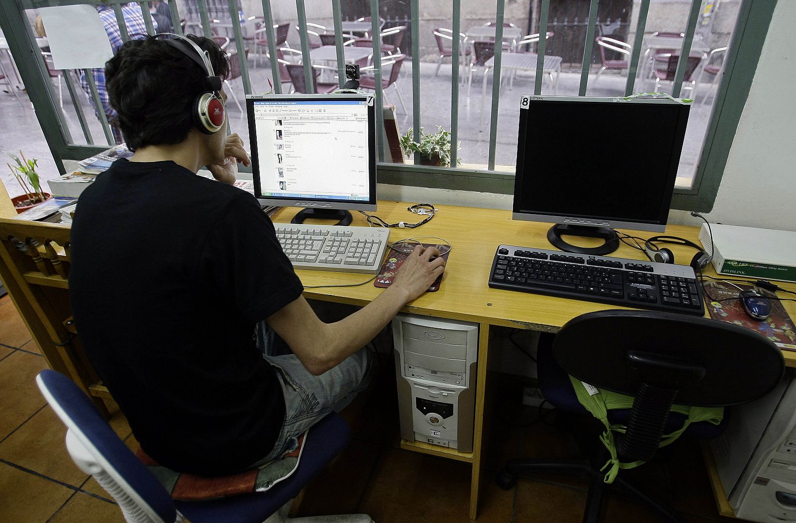 A man browses web at an Internet cafe in Madrid