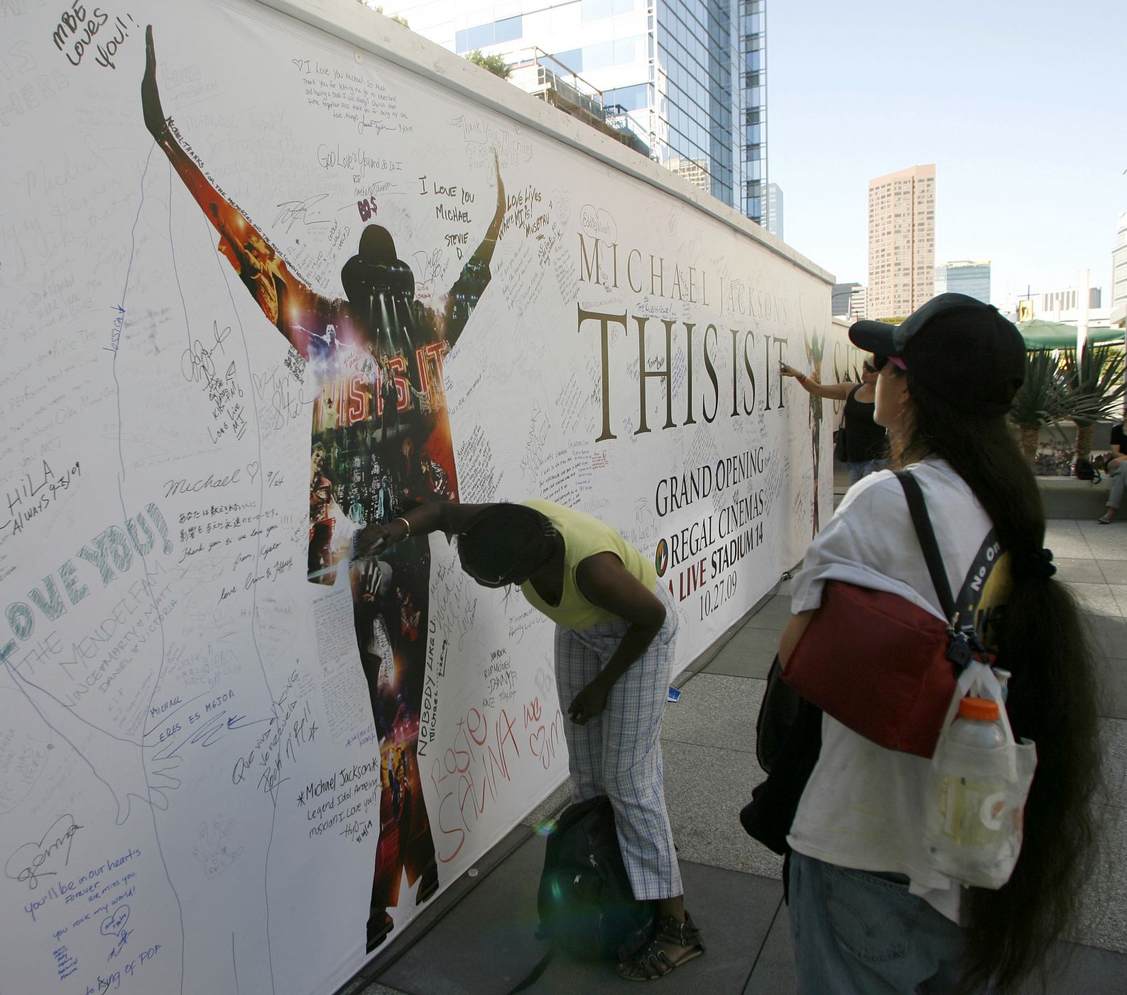 A woman signs a tribute wall for Michael Jackson at the L.A. Live complex