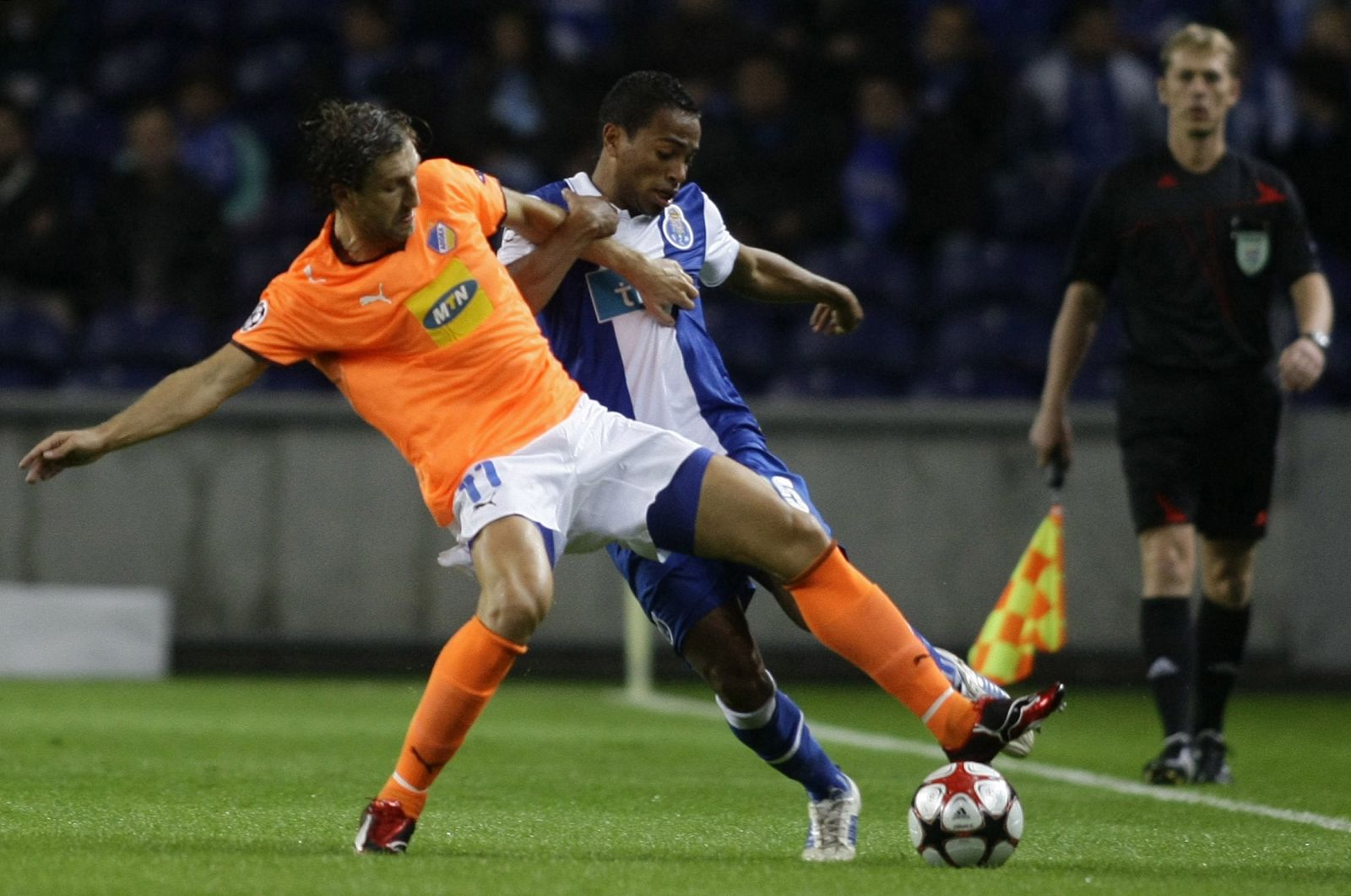 Porto's Pereira battles for the ball with Apoel Nicosia's Kosowski during their Champions League match in Porto