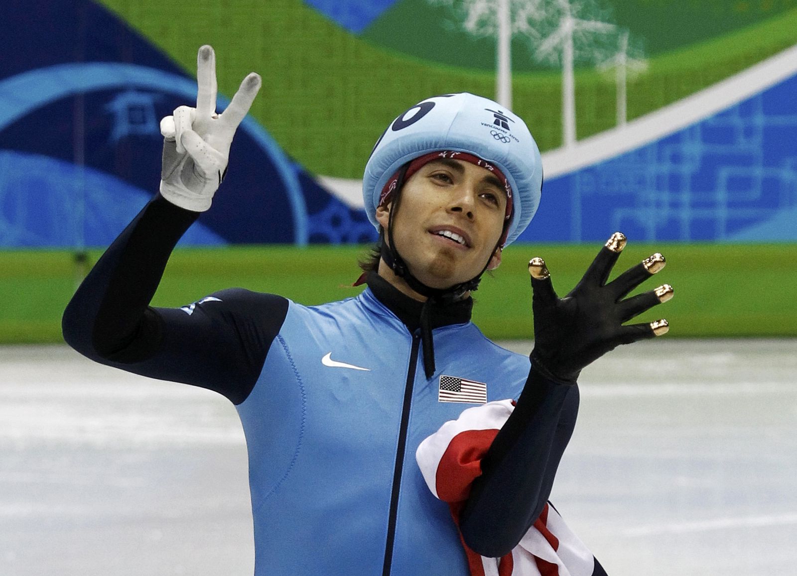Bronze medallist Ohno of the U.S. holds up his fingers to indicate his seven Olympic medals after the men's 1000 metres short track speed skating finals in Vancouver
