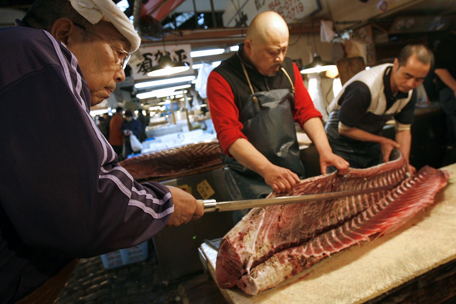 A wholesaler cuts a tuna at the Tsukiji fish market in Tokyo