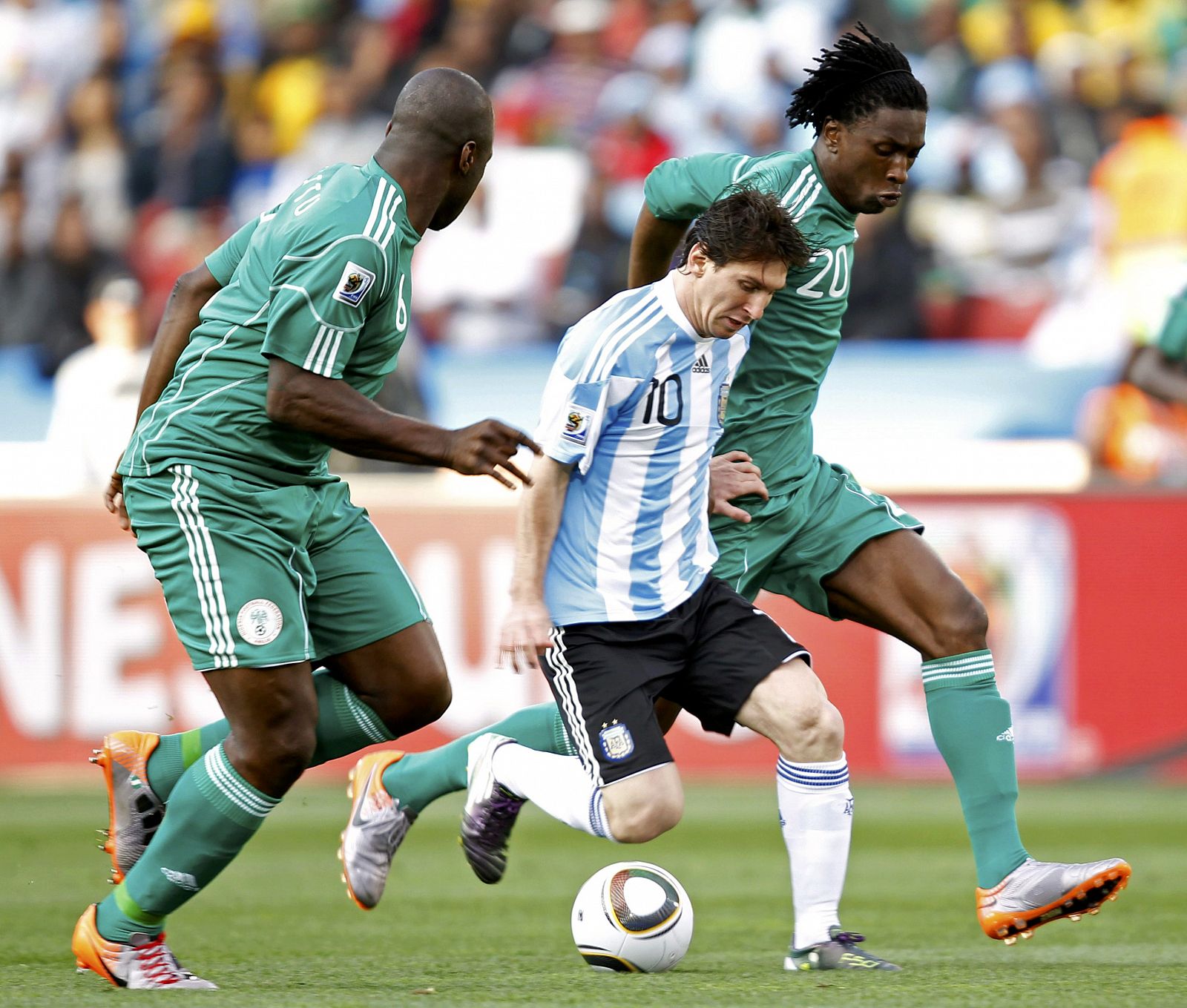 Argentina's Messi fights for the ball with Nigeria's Etuhu during a 2010 World Cup Group B soccer match at Ellis Park stadium in Johannesburg
