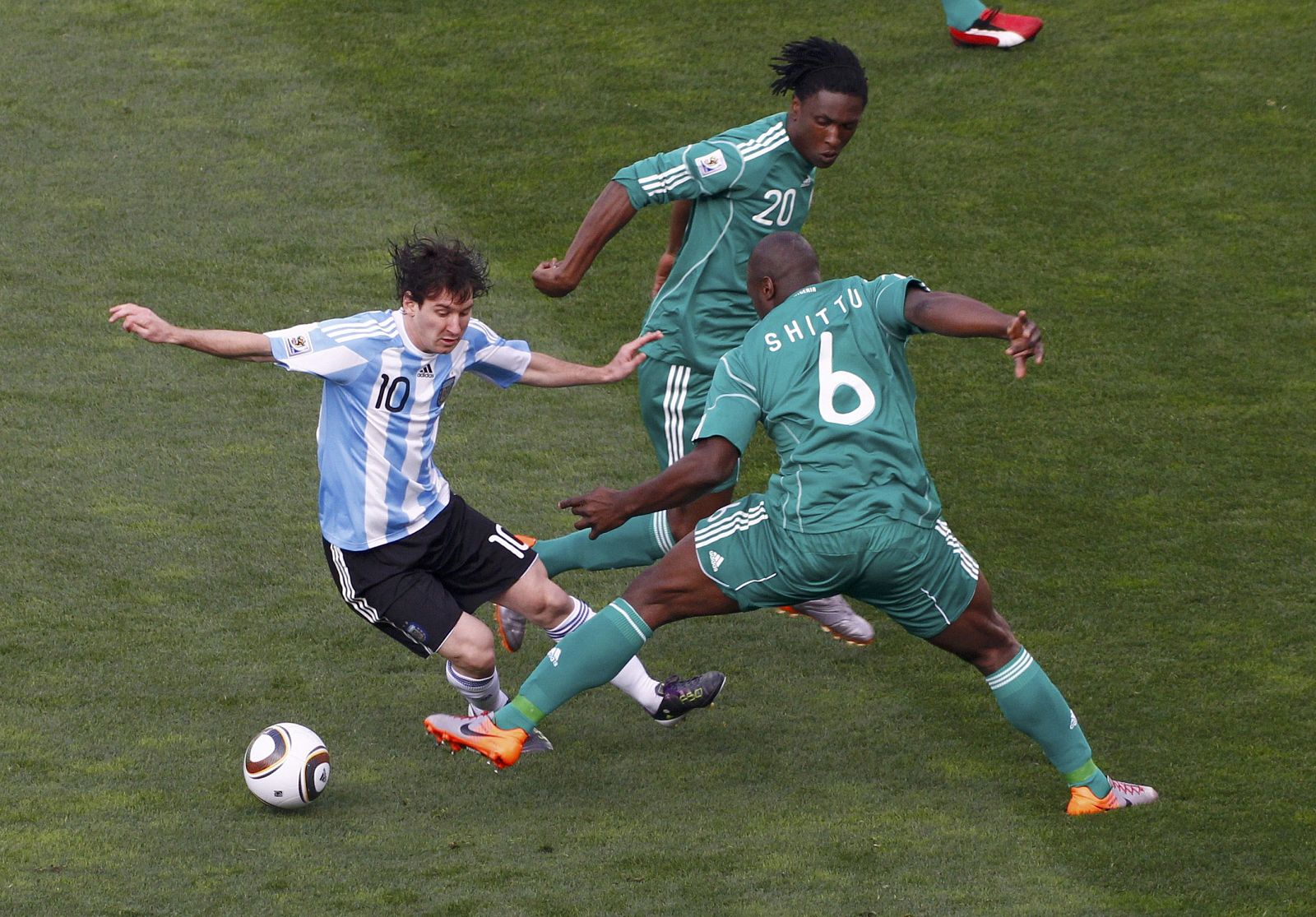 Argentina's Lionel Messi fights for the ball with Nigeria's Danny Shittu during a 2010 World Cup Group B soccer match at Ellis Park stadium