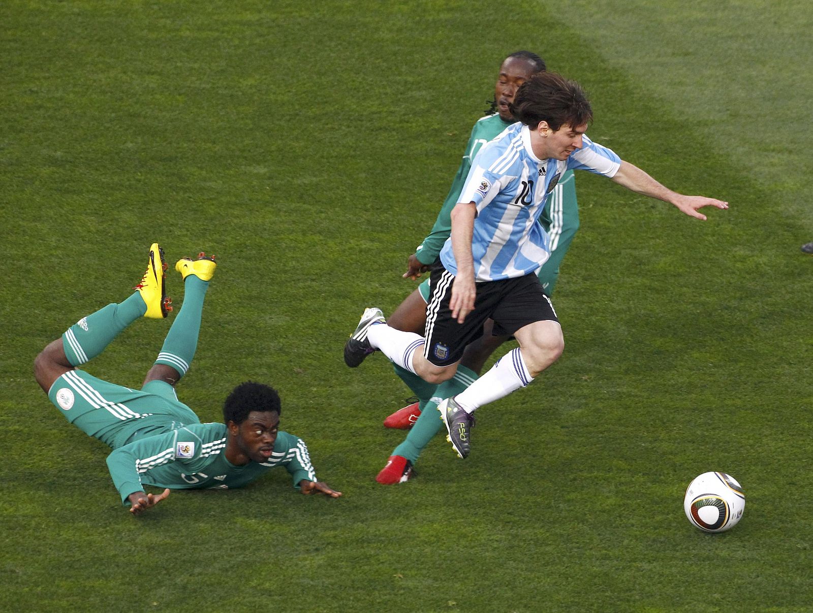 Argentina's Lionel Messi is fouled by Nigeria's Haruna Lukman during a 2010 World Cup Group B soccer match at Ellis Park stadium