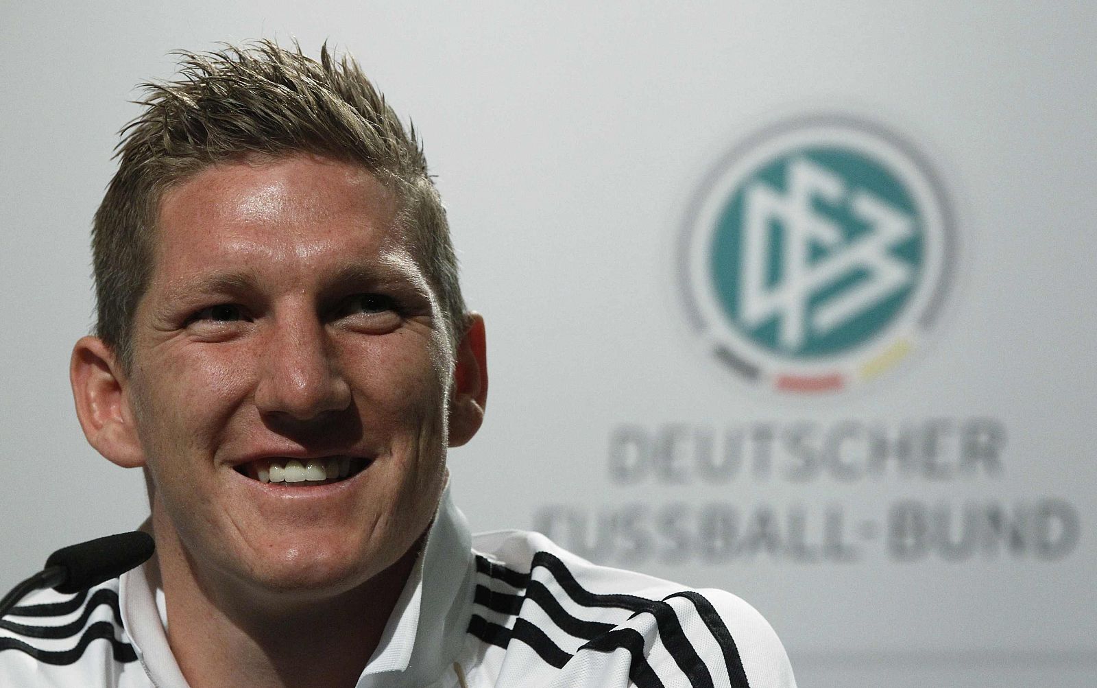 Germany's Schweinsteiger smiles during a news conference at the Velmore hotel in Pretoria