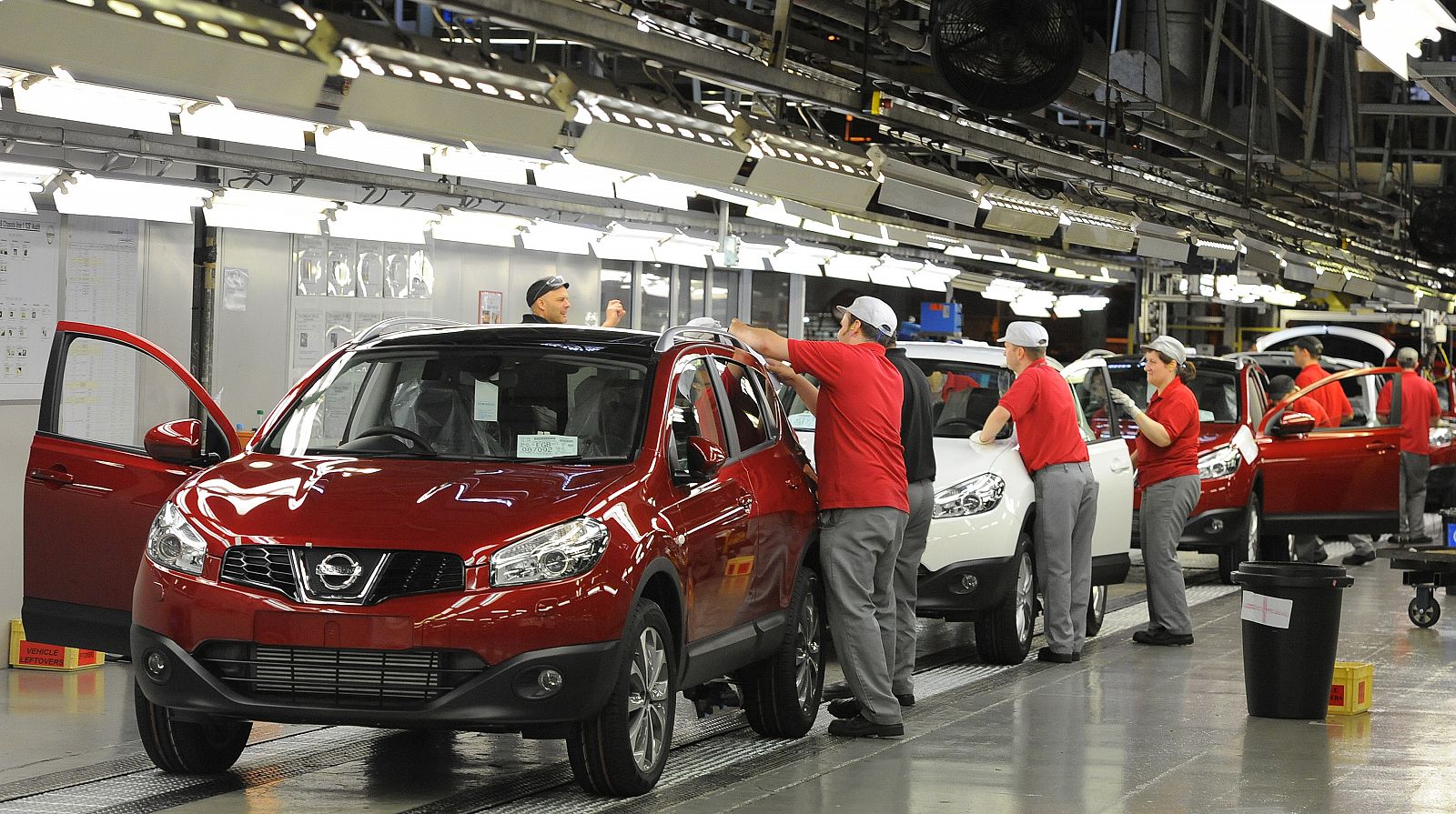 A worker is seen completing final checks on the production line at Nissan car plant in Sunderland