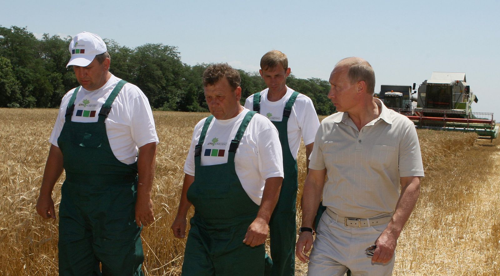 Russia's Prime Minister Putin, accompanied by workers, walks through the "Agrocomplex" Farm's wheat field in the southern Krasnodar Region