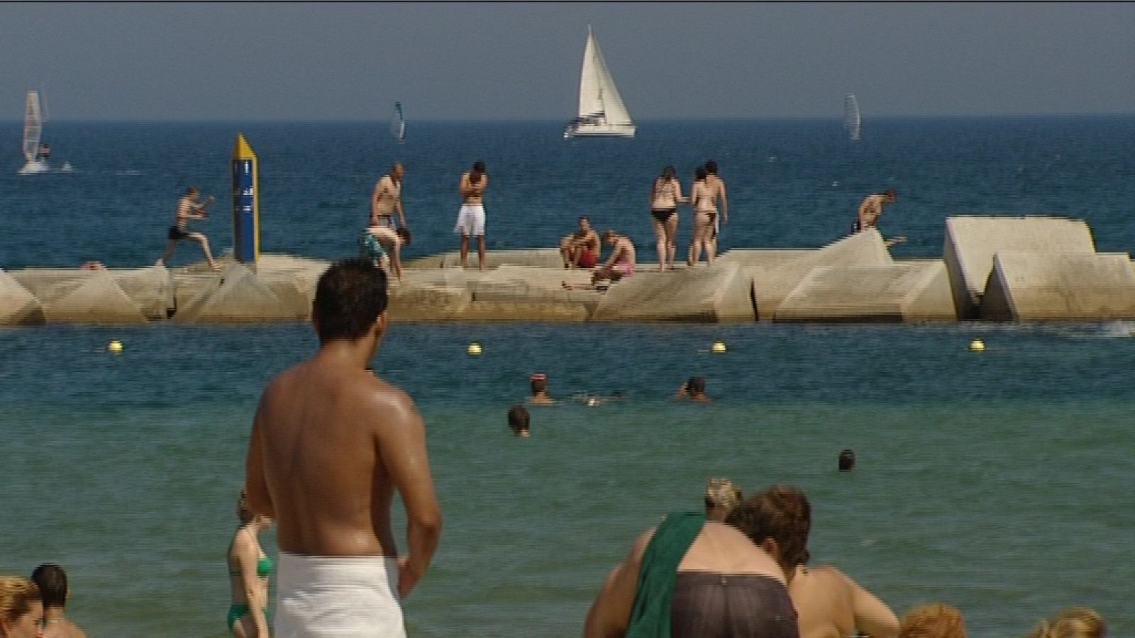 Grupo de turistas en uno de los espigones de las playas de Barcelona