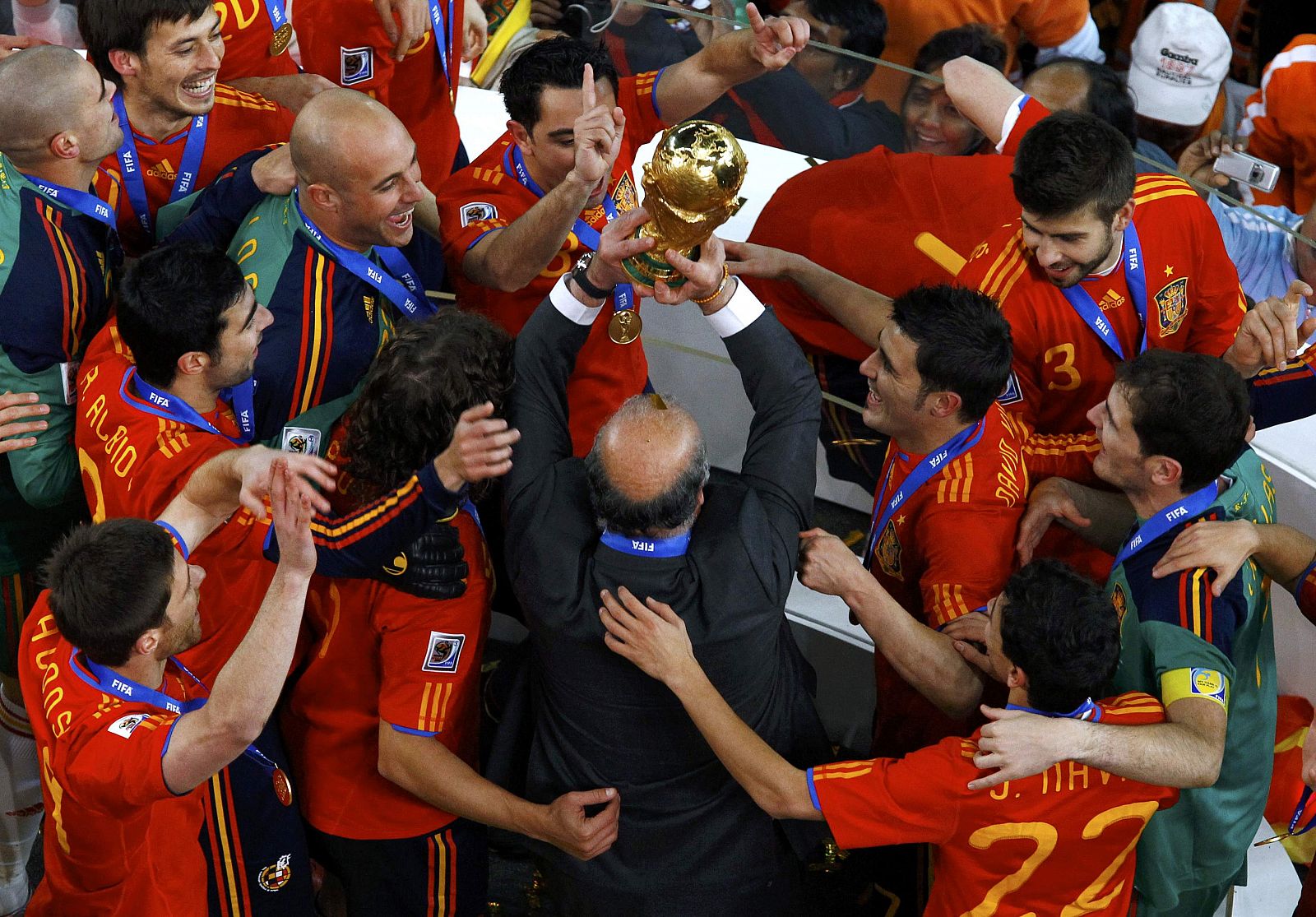 Spain's coach Vicente del Bosque (C) raises the World Cup trophy after their 2010 World Cup final win over Netherlands at Soccer City stadium in Johannesburg