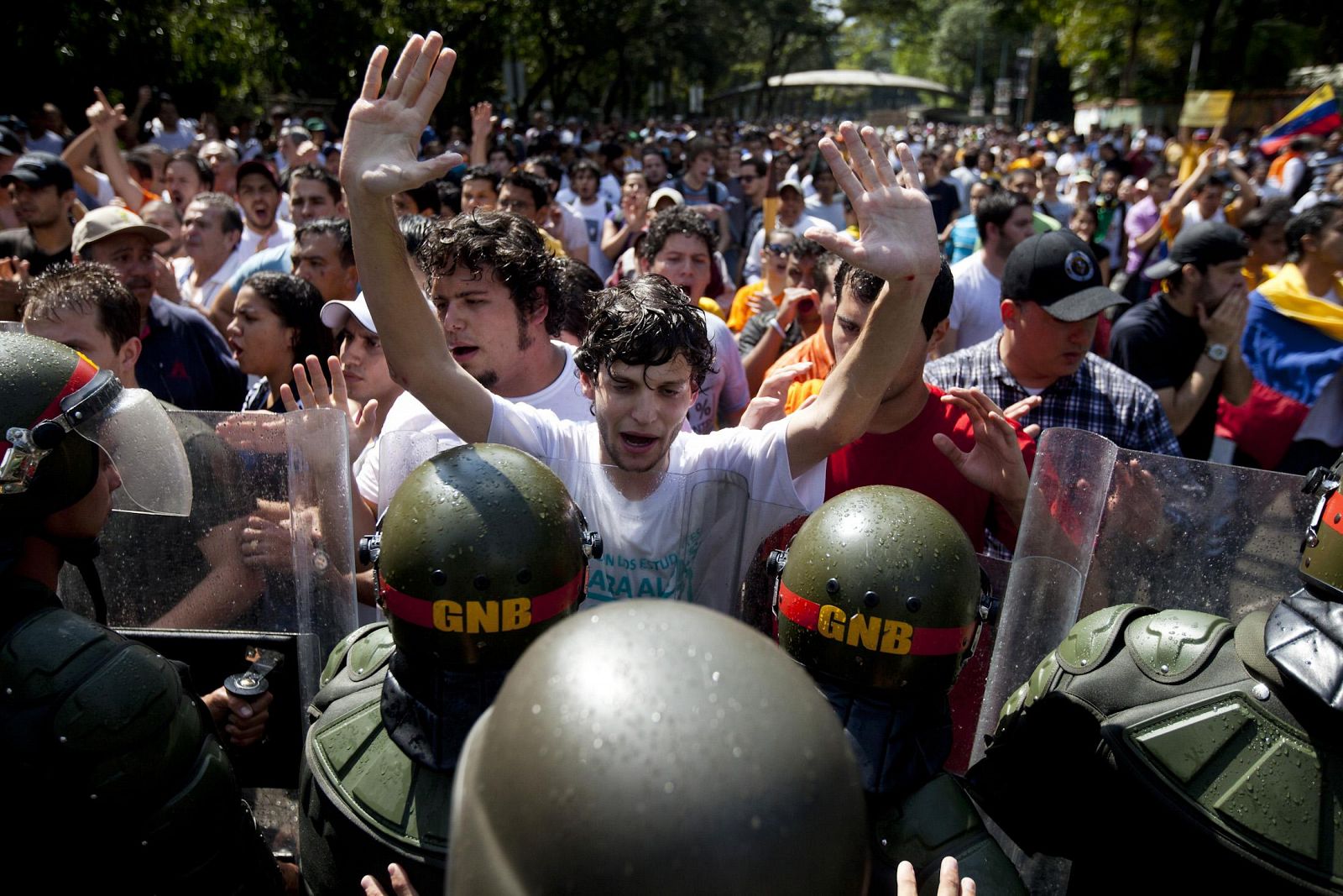 Venezuelan riot guards clash with students during a protest against Venezuela's President Hugo Chavez in Caracas